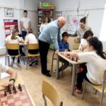 Michael Khodarkovsky, president of the Kasparov Foundation, challenged to a game of chess by one of the students of the Step by Step Middle School